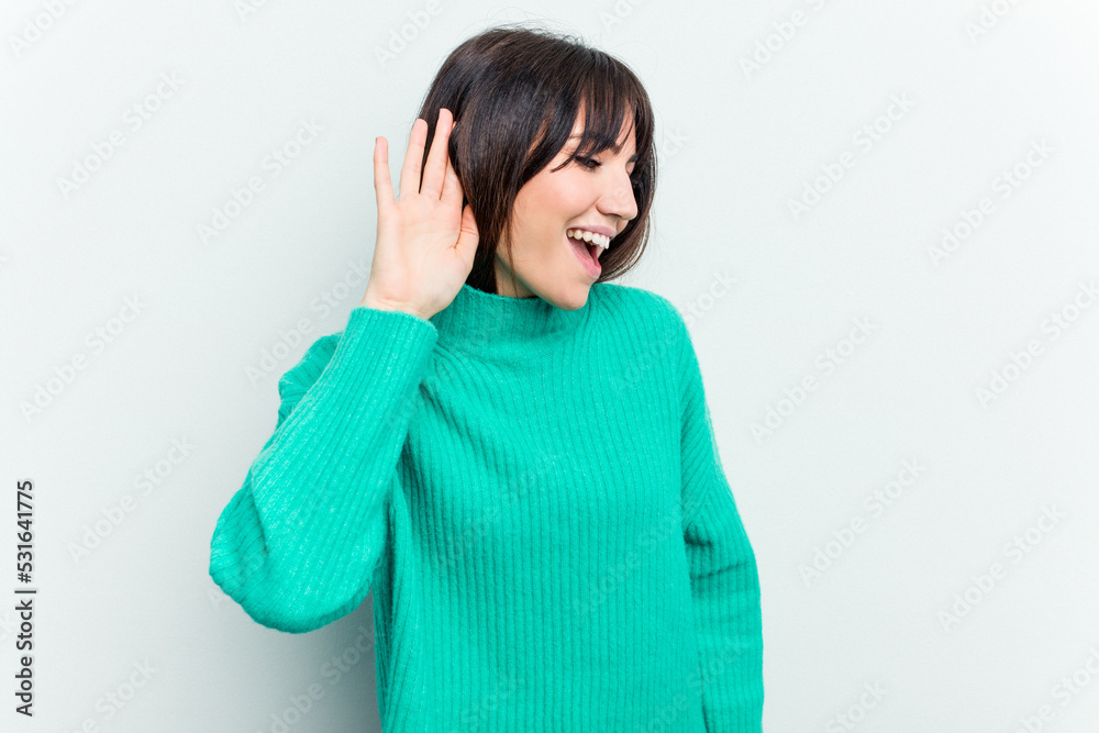 Young caucasian woman isolated on white background trying to listening a gossip. Young caucasian woman isolated on white background trying to listening a gossip.