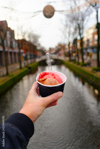 Ice cream at Delft , Canal city  and bridges with classic buildings since medieval : Delft , Netherlands : November 28 , 2019 photo