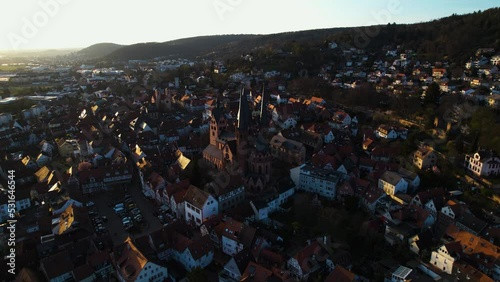 Aerial view towards the Evangelical Church in Gelnhausen, sunset in Hesse, Germany - pull back, drone shot photo