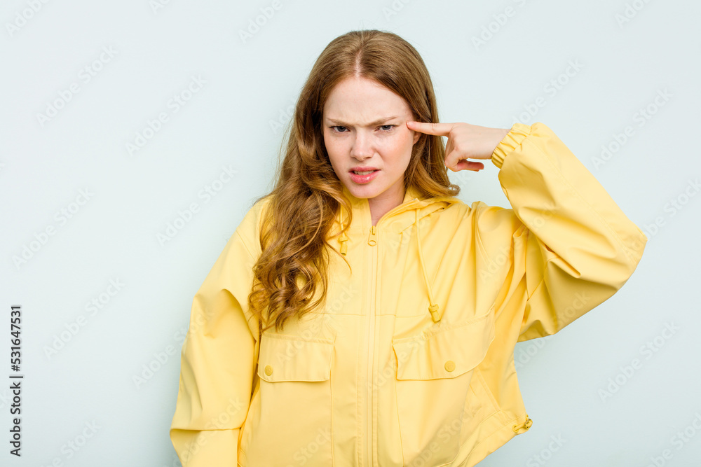 Young caucasian woman isolated on blue background covering ears with hands. Young caucasian woman isolated on blue background covering ears with hands.