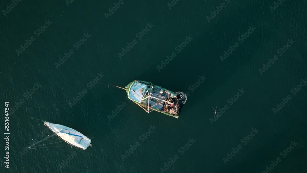 Aerial top dow view of many boats moored in tranquil sea water. Day time Aerial top dow view of many boats moored in tranquil sea water. Day time