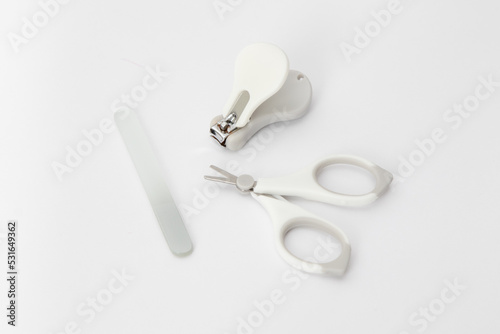 Baby nail care devices on a white background: scissors, nail file, nail clipper. Child hygiene items