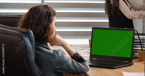 Fotografie Business woman or female freelancer watching a webinar on green screen chroma key laptop