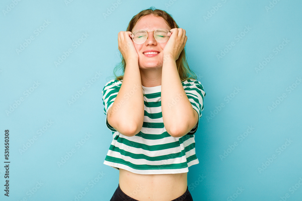Young caucasian woman isolated on blue background crying, unhappy with something, agony and confusion concept. Young caucasian woman isolated on blue background crying, unhappy with something, agony and confusion concept.