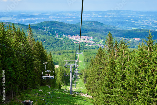 Beautiful mountains, covered with forest and open cable car line. Karpacz resort in Poland with lift road. Family outdoor recreation in mountains