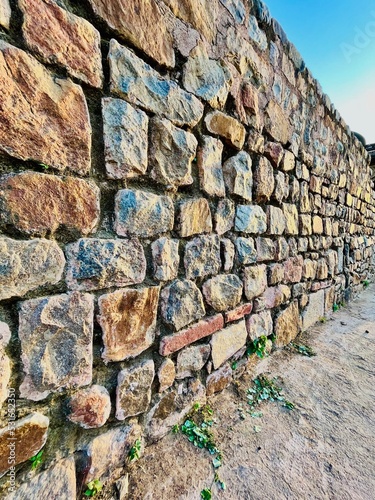 One with the stone wall background. Wall ideas for a wall made of stones having a unique texture and a 3D look. Ideas for home decor, wall decor, portrait photography, model photo-shoot. 