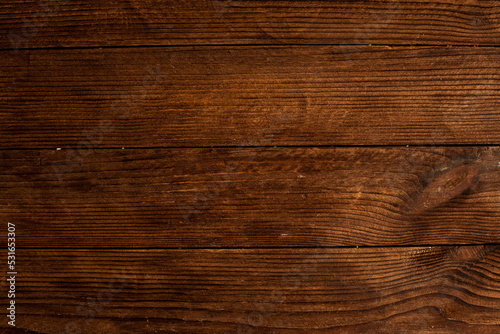 Vintage brown wood background texture with knots and nail holes. Old painted wood wall. Brown abstract background. Vintage wooden dark horizontal boards. Front view with copy space. Background for des