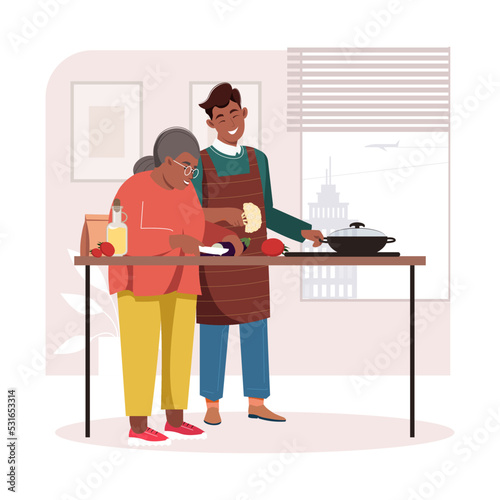 Elderly African American woman and her son preparing dinner together. Smiling grandmother teaching her grandson how to cook, spending time together. Old woman with grandchildren in the kitchen.