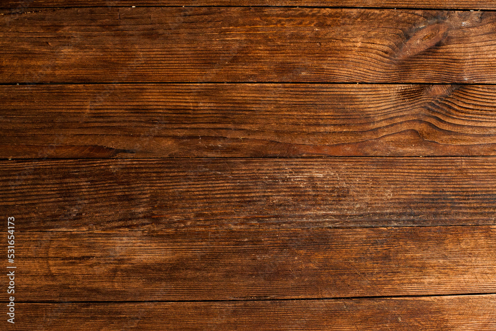 Fototapeta premium Vintage brown wood background texture with knots and nail holes. Old painted wood wall. Brown abstract background. Vintage wooden dark horizontal boards. Front view with copy space. Background for des
