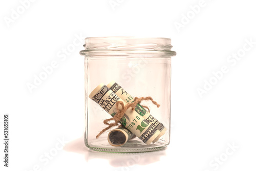 Fotografiet Many 100 US dollars bank notes in a glass jar isolated on white background