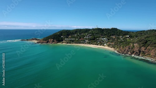 Wallpaper Mural Drone orbits around Wategos Beach in Byron Bay on a beautifully calm morning. Surfers surfing on small waves in crystal clear water. Green forest backdrop. Aerial shot in 5.4K. Torontodigital.ca