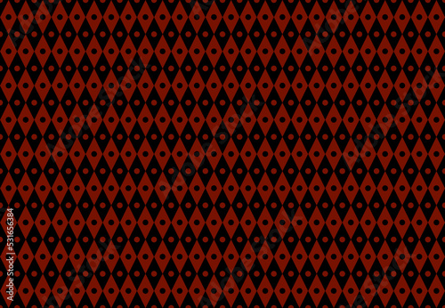 Seamless design with repeated black and red rhombuses or diamonds and small opposite color circles in the middle of each of them, harlequin inspired pattern with elongated shapes arranged vertically photo