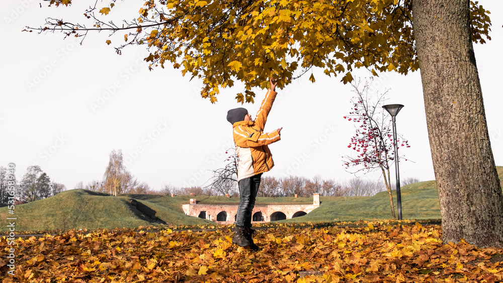 Children play in the autumn park Children play in the autumn park
