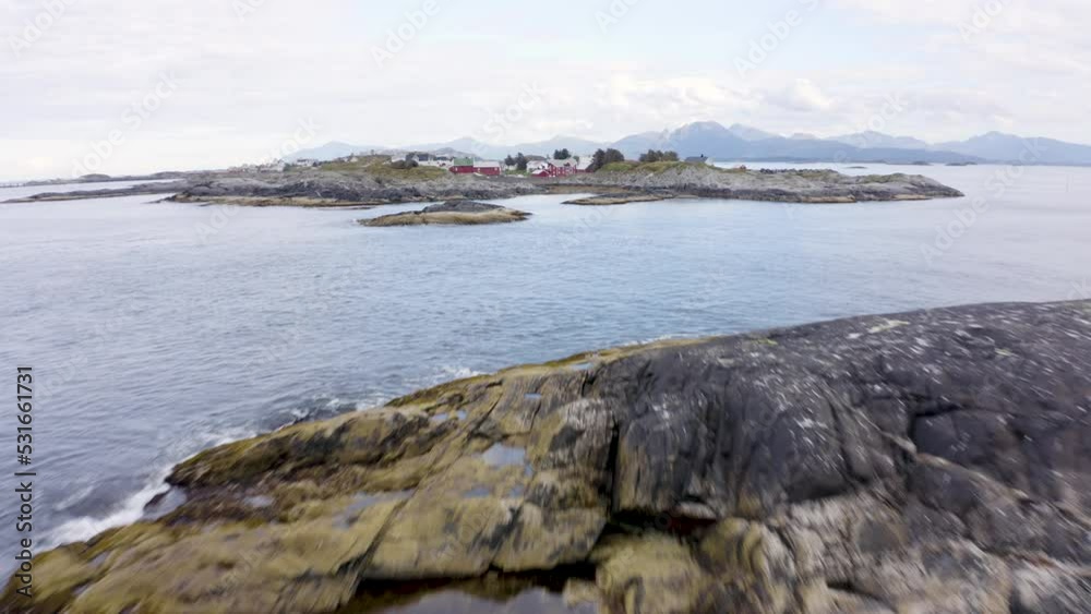 Areal reveal shot of small settlement on a nordic island. Areal reveal shot of small settlement on a nordic island.