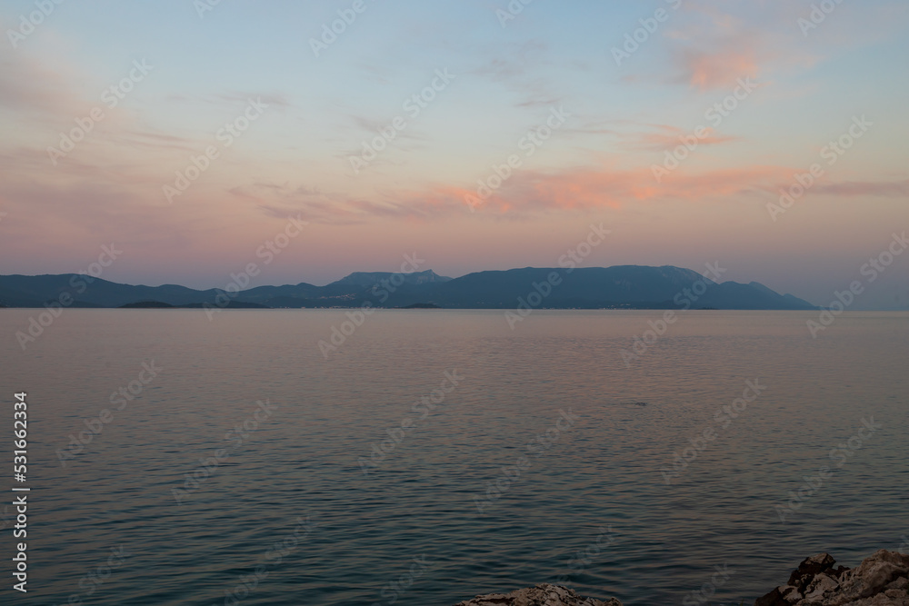 Fototapeta premium Seaside landscape in the sunset. Region Croatia - Duba - Europe. Sea, boats and sunset.