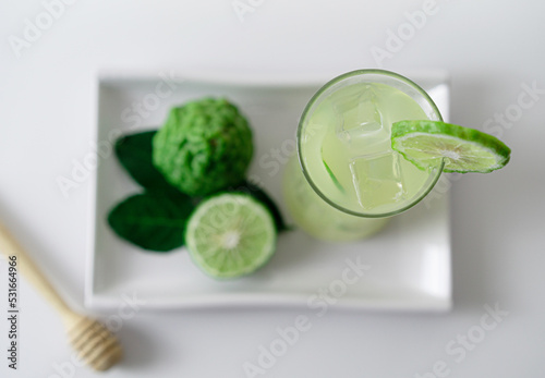 Top view a glass of fresh bergamot juice on white tray