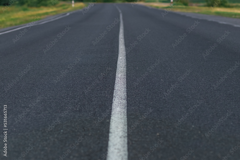 Asphalt road going into the distance on a summer evening Asphalt road going into the distance on a summer evening