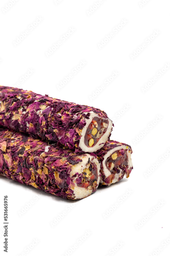 Turkish delight with pistachio isolated on white background. Turkish delight covered with rose petals. Close-up. local name gullu fitil lokum Turkish delight with pistachio isolated on white background. Turkish delight covered with rose petals. Close-up. local name gullu fitil lokum