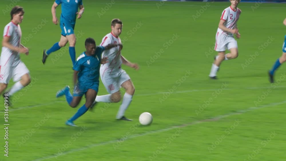 Soccer Football Match Championship: Blue Team Players Attacks, Falls when Pushed and Loses Ball to Foul. Dynamic Game on Tournament. Sport Broadcast Channel Television Playback. TV Tracking Shot Soccer Football Match Championship: Blue Team Players Attacks, Falls when Pushed and Loses Ball to Foul. Dynamic Game on Tournament. Sport Broadcast Channel Television Playback. TV Tracking Shot