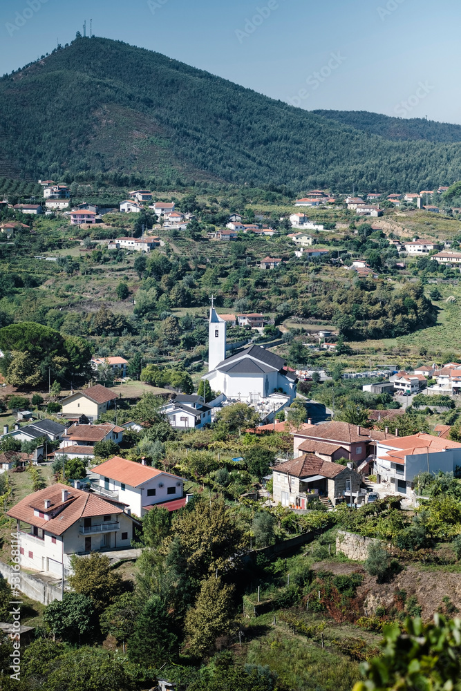 View of the village houses and a church in the hills of the Douro Valley, Porto, Portugal.