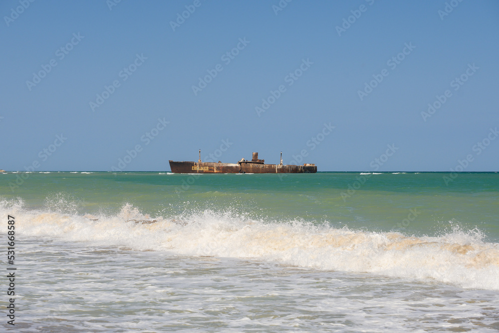 Old rusty shipwreck. Wreck in the waves of the sea. Romania, Costinesti. August, 12, 2022 Old rusty shipwreck. Wreck in the waves of the sea. Romania, Costinesti. August, 12, 2022