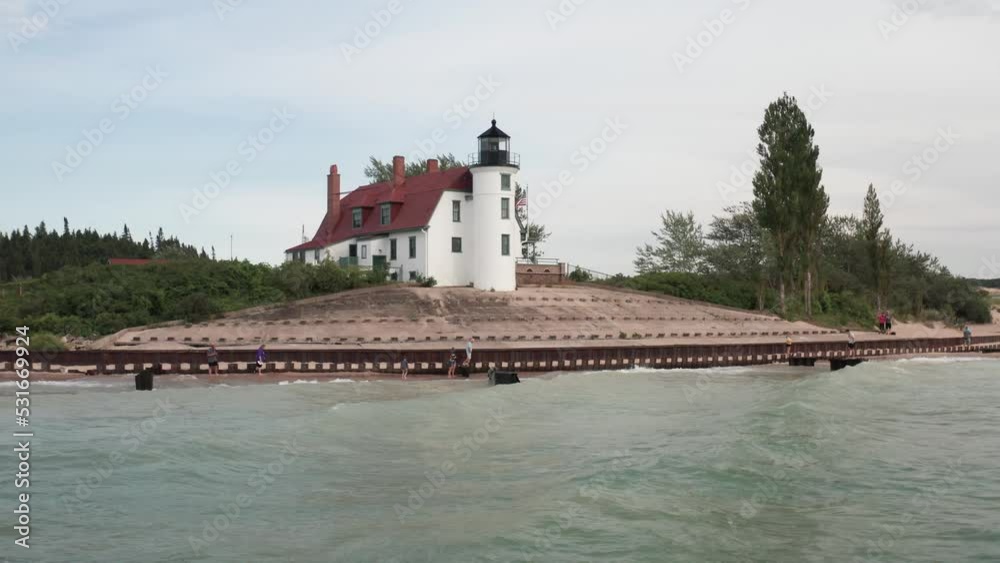 Historic Point Betsie Lighthouse in Frankfort, Michigan located along Lake Michigan with drone video low on water moving in. Historic Point Betsie Lighthouse in Frankfort, Michigan located along Lake Michigan with drone video low on water moving in.