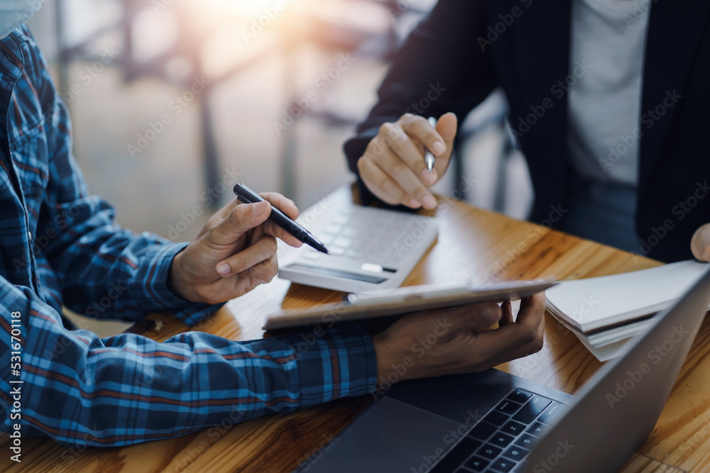 Close-up of business people taking note at a meeting on clipboard for drafting, writing meeting minutes in office and printing on computer. Close-up of business people taking note at a meeting on clipboard for drafting, writing meeting minutes in office and printing on computer.