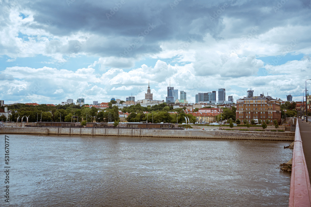 Cloudy day of the big city in Warsaw in summer, Poland skyscrapers of tall buildings on the horizon above the surface of the Vistula river. city ​​panorama beautiful cityscape