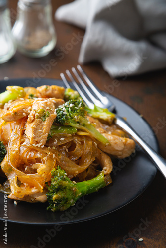 Stir fry, bean noodles with fried chicken fillet and broccoli