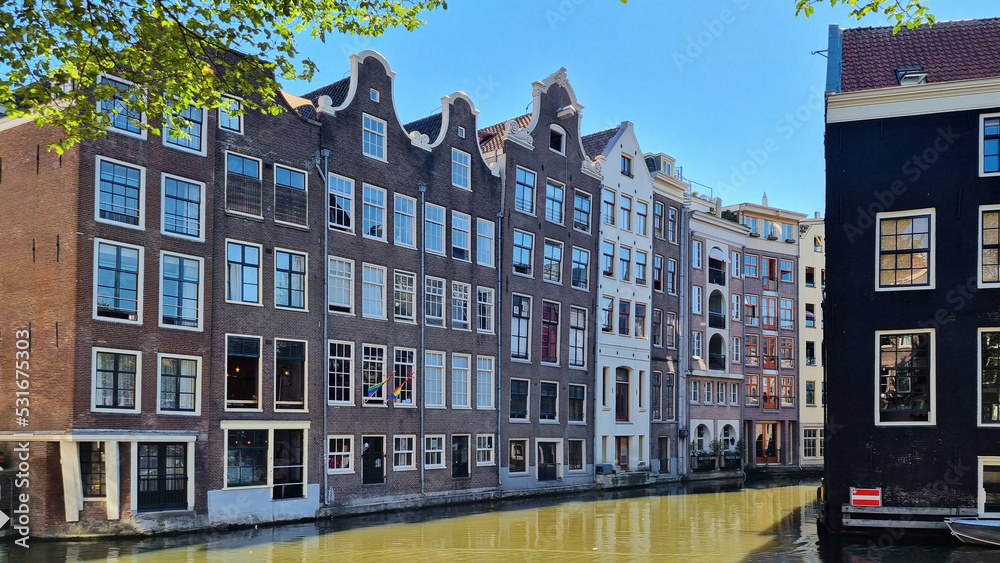 Channel in Amsterdam Netherlands. Houses river Amstel landmark. Old European city summer landscape