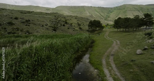 Car's Tire Tracks Along The Tsundi Lake With Reed Grass In Tmogvi, Georgia. - aerial photo