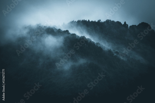 Cinematic view of fog in the mountains Dark and dramatic landscape Rainy season and climate change © UMB-O