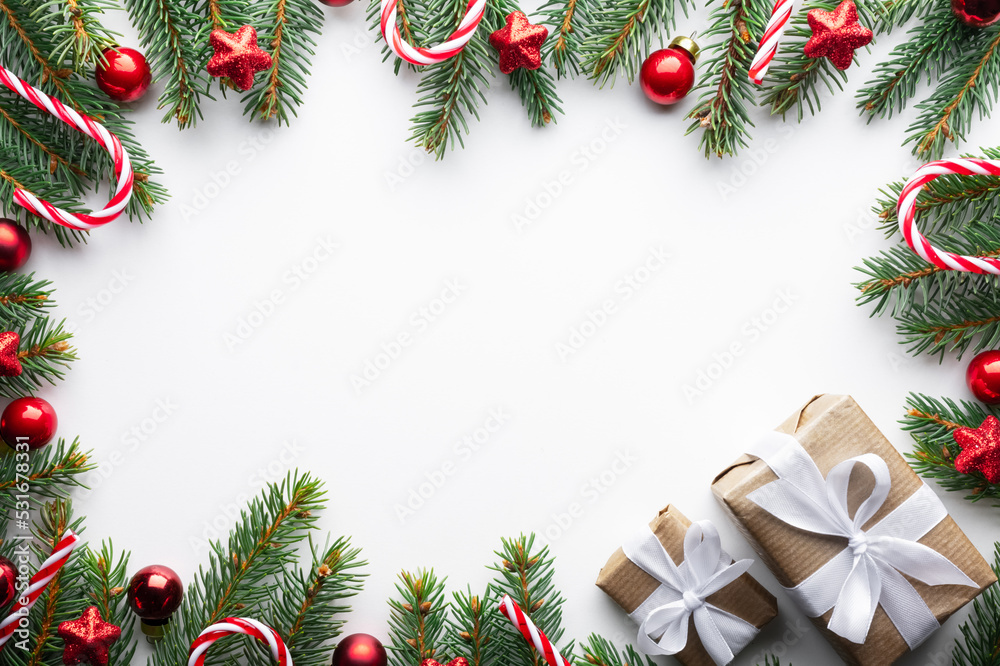 Creative Christmas background with Christmas balls, pine twigs and golden stars decorations on white background. Flat lay, top view, copy space Creative Christmas background with Christmas balls, pine twigs and golden stars decorations on white background. Flat lay, top view, copy space