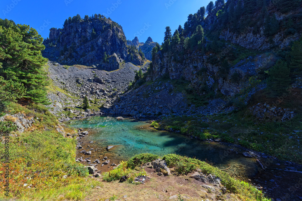Green colors of Leama lake in its small valley