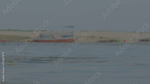 A man taking a dip in ganga river in varanasi ghat photo