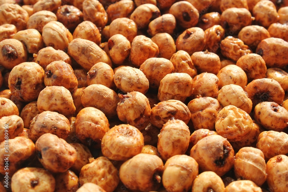 Close-up of chufa, tigernut, earth almond preparing for traditional typical tasty homemade cold fresh drink horchata from Valencia, Spain. Healthy organic food concept. Tiger nut for flour and milk Close-up of chufa, tigernut, earth almond preparing for traditional typical tasty homemade cold fresh drink horchata from Valencia, Spain. Healthy organic food concept. Tiger nut for flour and milk