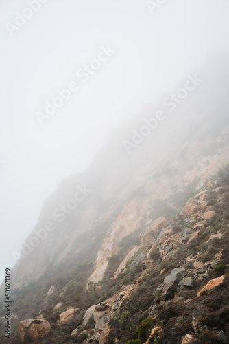 Morning mist fog haze on Morro rock California. USA travelling along the highway 101. Volcanic plug formation