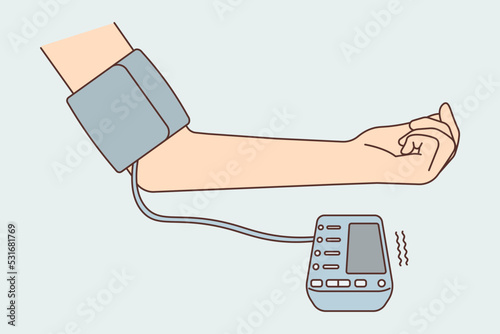 Patient hand with blood pressure monitor 