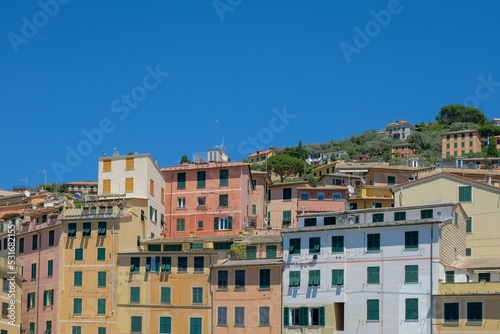 Colorful residential buildings on a hillside with deep blue sky in the Itailian village of Camogli.