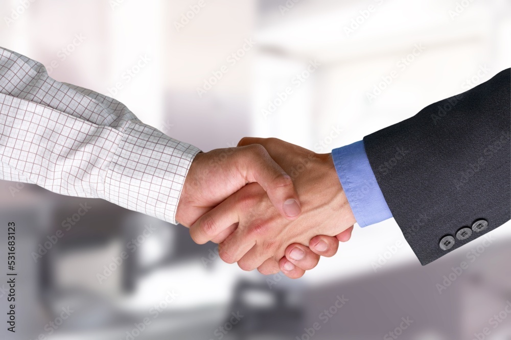 Business person shaking hands after meeting in office Business person shaking hands after meeting in office