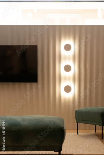Vertical view of basement contenporary interior design with dorecative lights and velvet sofa photo