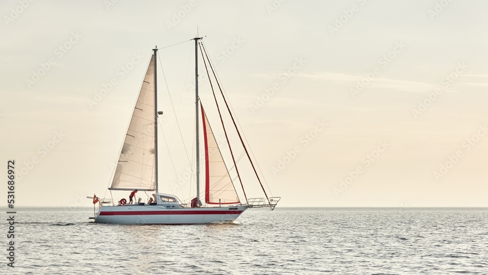 Modern two masted sailboat sailing in the Baltic sea on a clear day. Transportation, yacht cruise, yachting, regatta, sport, recreation themes. Travel, exploring, wanderlust concepts