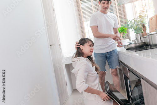 happy asian couple cooking healthy food. attractive wife and cheerful husband preparing delightful meal with fresh ingredients. smiling boyfriend and girlfriend making breakfast support each other