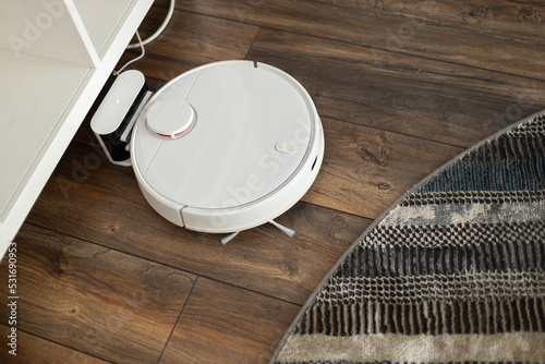 Robotic vacuum cleaner on laminate wood floor smart cleaning technology
