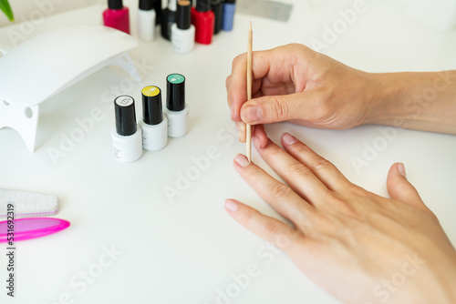 Covering your nails with gel polish at home  your own master  clean the cuticles. Professional hand care  home spa.