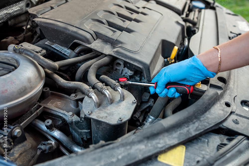 Car mechanic repairman hands repairing car engine of car workshop with wrench and service. Car mechanic repairman hands repairing car engine of car workshop with wrench and service.