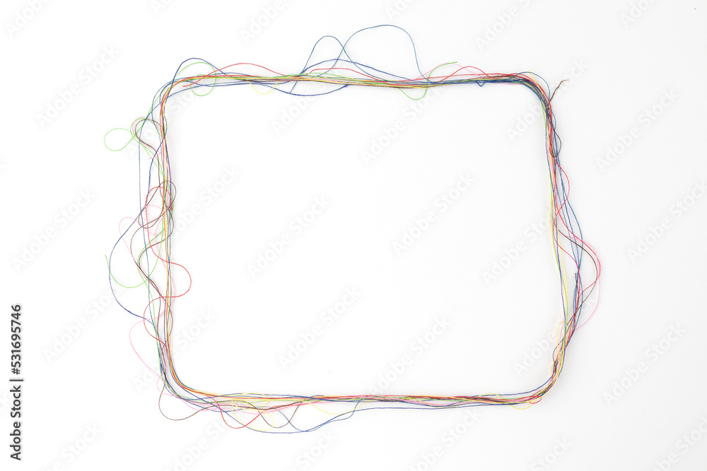 frame of colored sewing thread on white background frame of colored sewing thread on white background