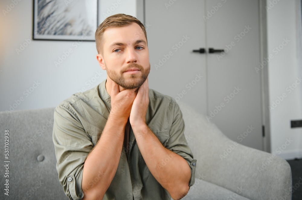 Fototapeta premium Sore throat. Dark-haired young man having a sore throat.