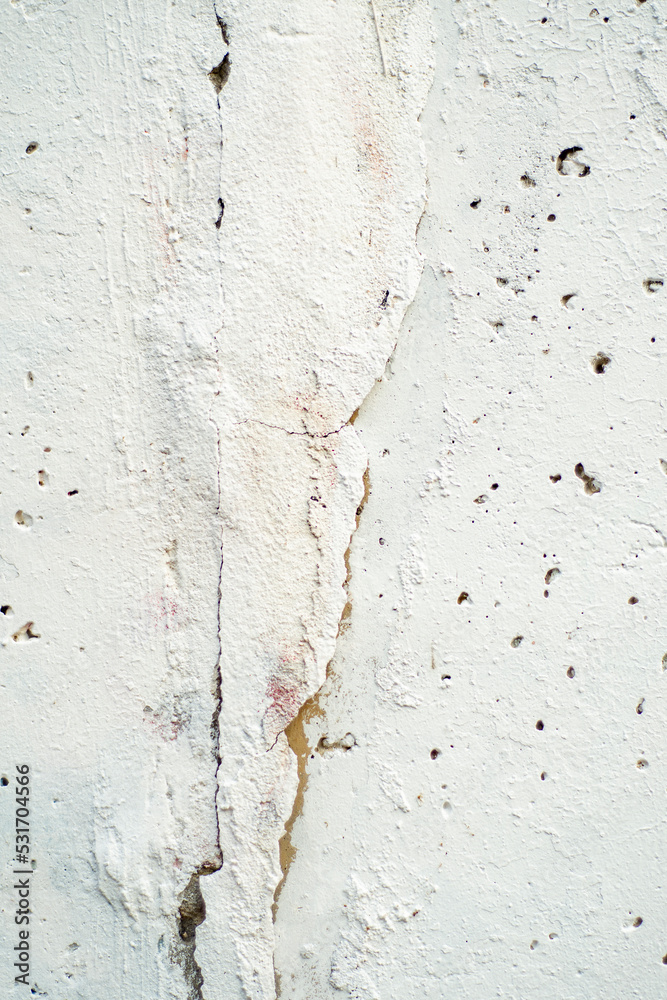 Background with a concrete wall messily painted with white paint.