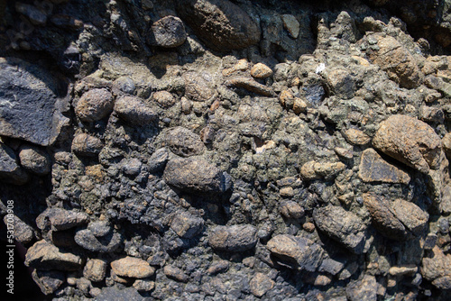 Natural stone background with rough textured surface. Sea rock texture. close-up. Blurred and defocused background